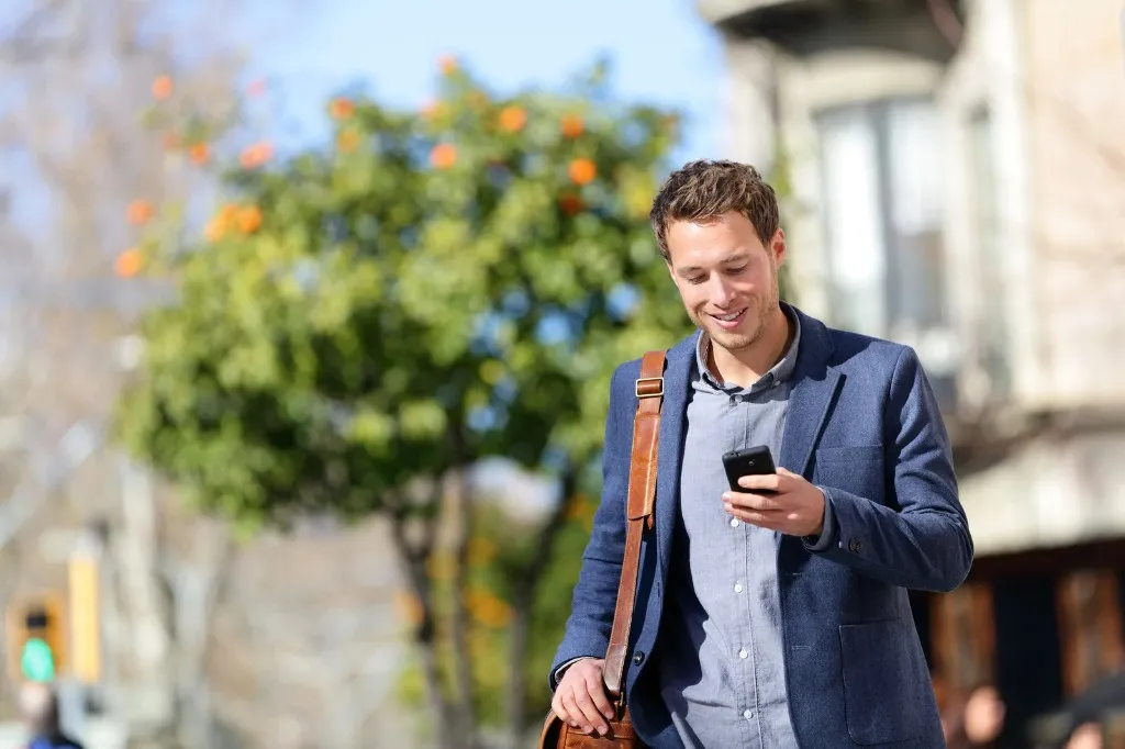 Professional using a smartphone outdoors